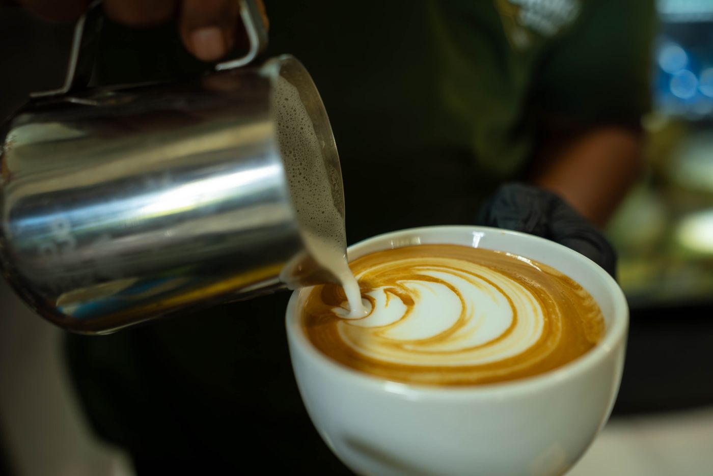 Barista pouring latte art at the Brew Wagon