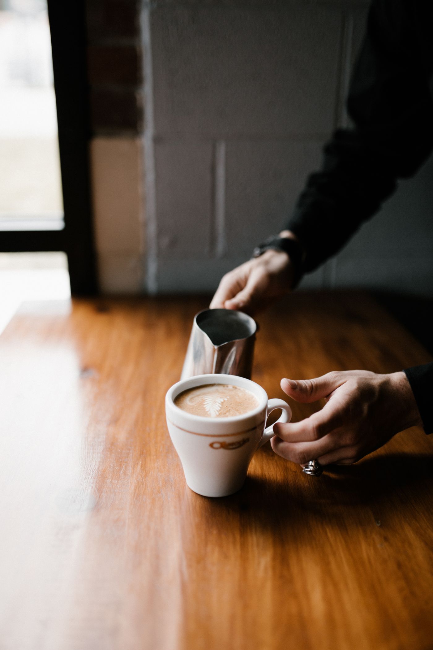 Steamed milk poured into espresso creating latte art