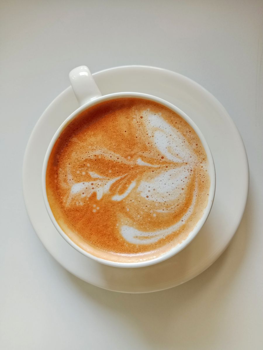 Flat lay of freshly poured coffee with latte art