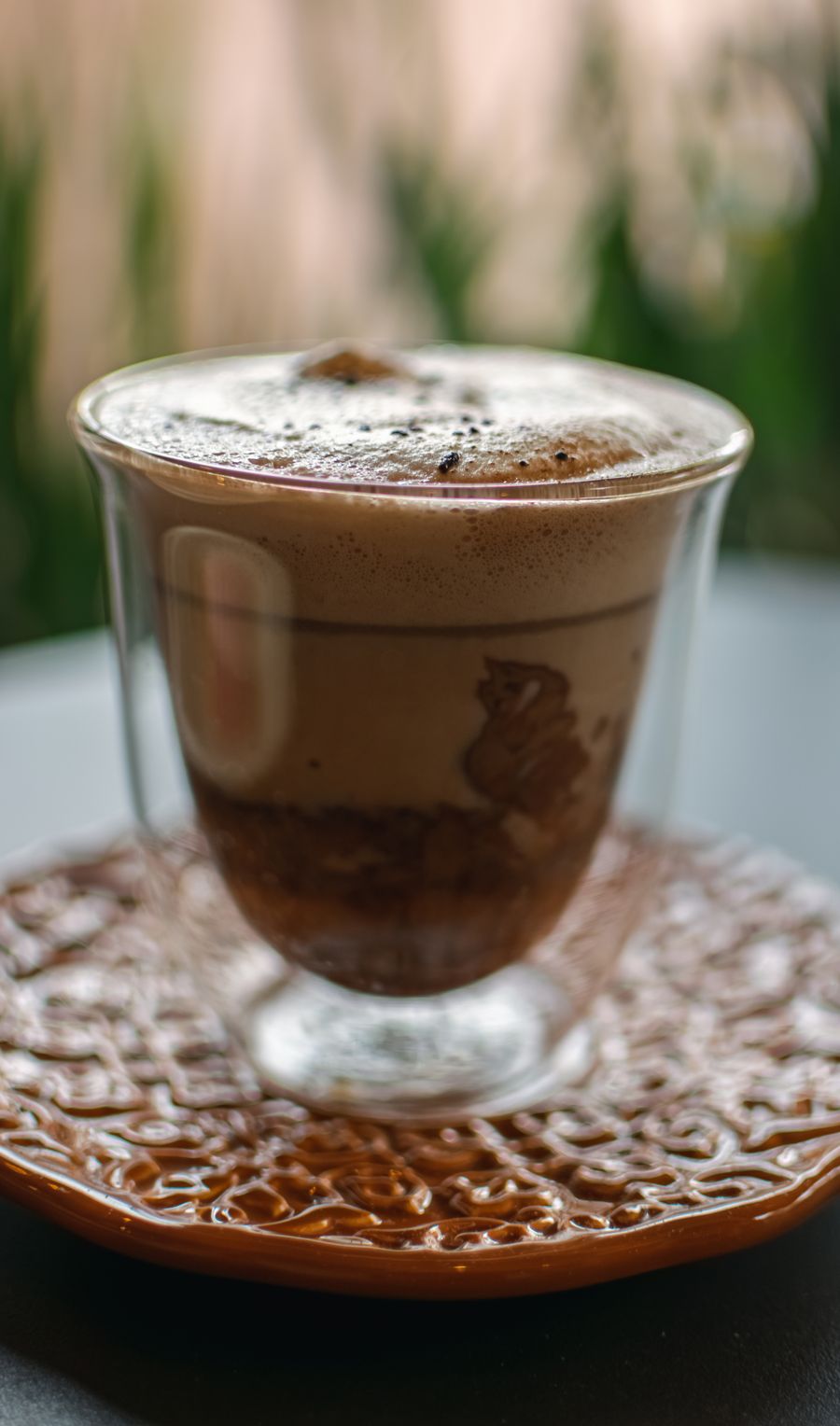 Mocha latte with chocolate on a clear glass cup