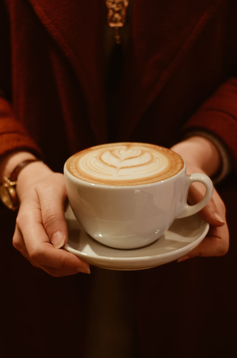 Customer warming their hands on a fresh cup